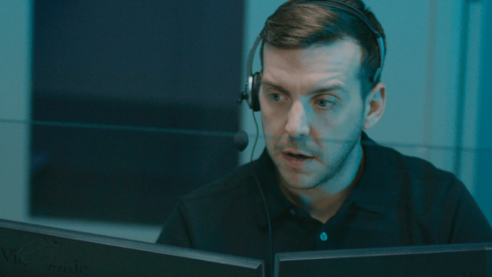 Monitoring specialist talking with a customer on a headset
