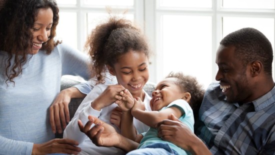 Happy family relaxes securely in their home