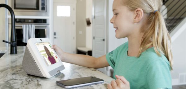 little girl talking to family on monitor