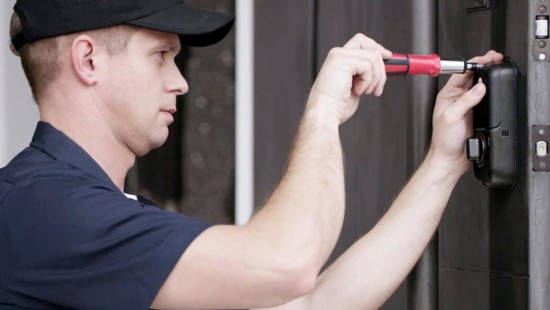 installer adding a video doorbell to a front door