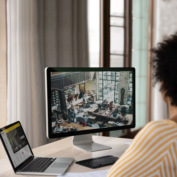 female boss looking at Guardian Alarm business cameras 